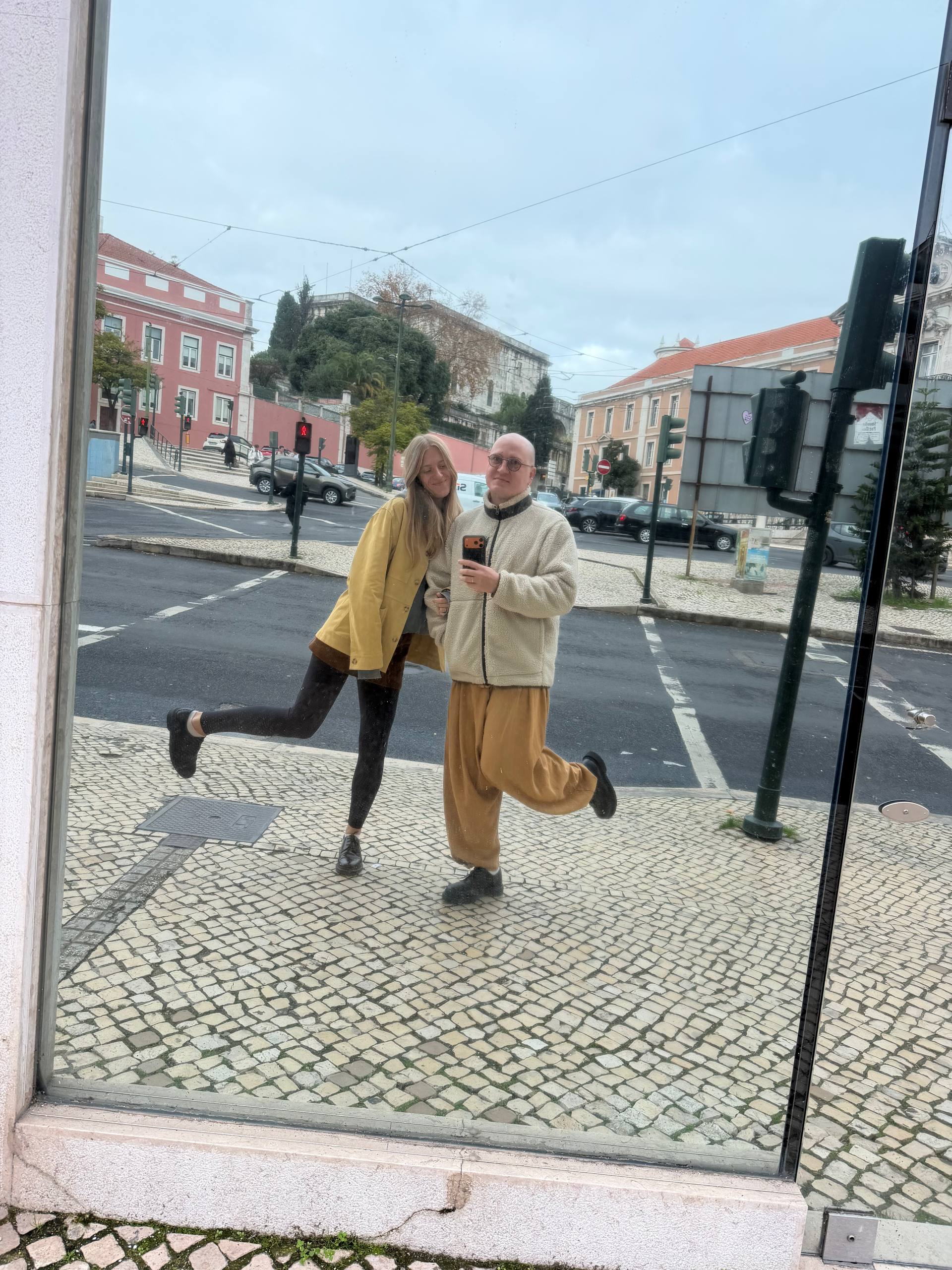 Liza and Ruslan reflected in a Lisbon shop window